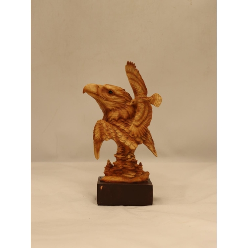 109 - A WOODEN CARVED EAGLE'S HEAD ON A PLINTH, HEIGHT 25CM