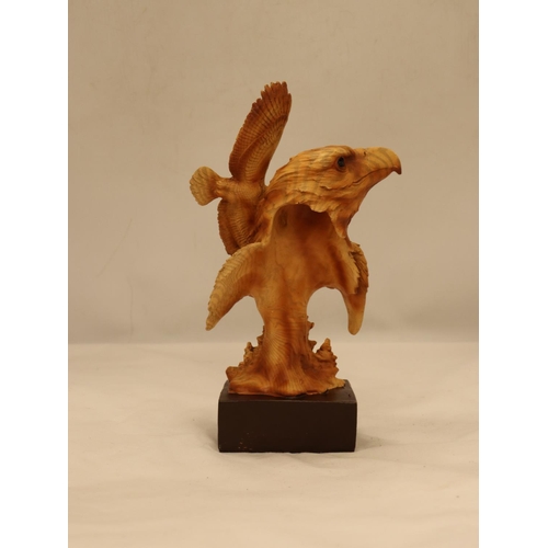 109 - A WOODEN CARVED EAGLE'S HEAD ON A PLINTH, HEIGHT 25CM