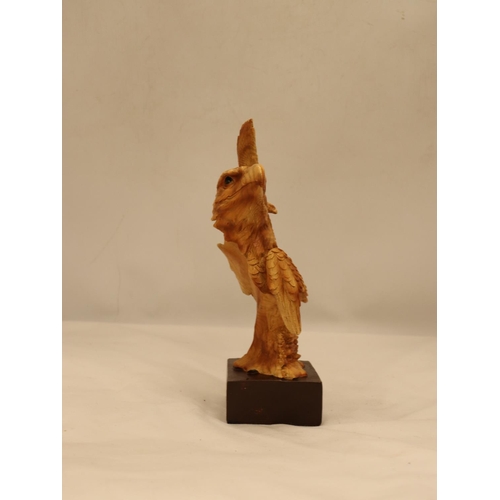 109 - A WOODEN CARVED EAGLE'S HEAD ON A PLINTH, HEIGHT 25CM