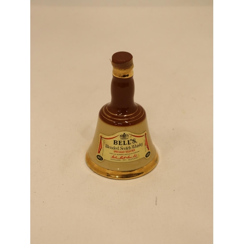 117 - A SMALL FULL BELL'S CERAMIC WHISKY DECANTER, HEIGHT 10CM