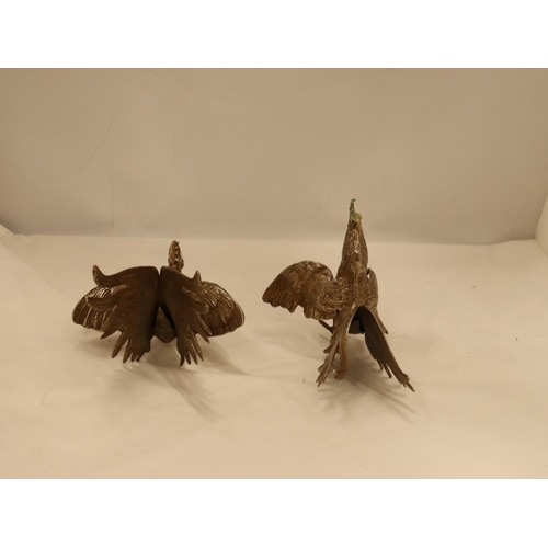 152 - A PAIR OF VINTAGE WHITE METAL FIGHTING COCK FIGURES