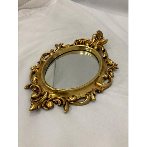 205 - A SMALL OVAL GILT MIRROR, PLEASE NOTE THE SIZE, 19CM X 29CM