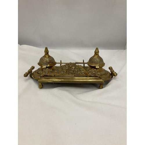 208 - AN ORNATE VINTAGE BRASS INKWELL STAND