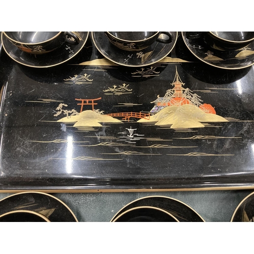 220 - AN ORIENTAL HANDPAINTED, LACQUERED TRAY WITH SIX CUPS AND SAUCERS