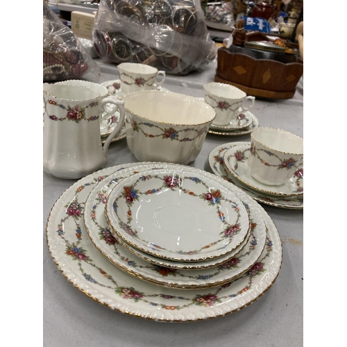 232 - AN ANTIQUE CHINA PART TEASET TO INCLUDE A CAKE PLATE, SUGAR BOWL, CREAM JUG, CUPS, SAUCERS AND SIDE ... 