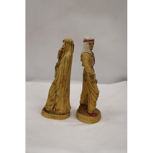 253 - TWO VERY HEAVY SHEIKH AND ARAB LADY FIGURES, HEIGHT 31CM