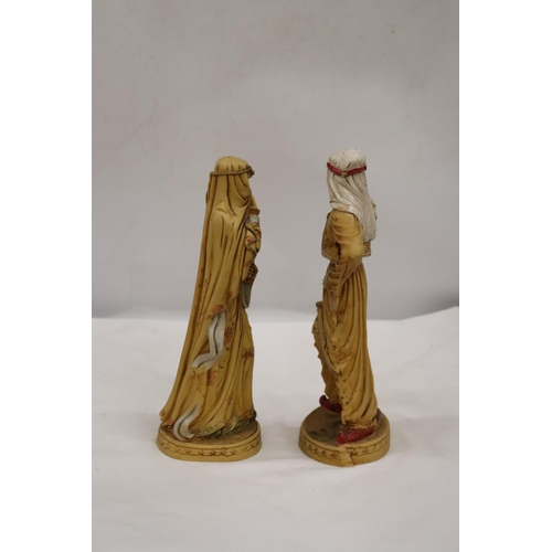 253 - TWO VERY HEAVY SHEIKH AND ARAB LADY FIGURES, HEIGHT 31CM