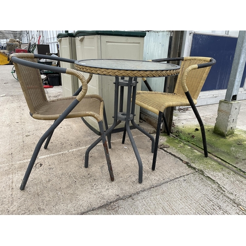 1629 - A GLASS TOPPED BISTRO TABLE AND TWO RATTAN EFFECT CHAIRS