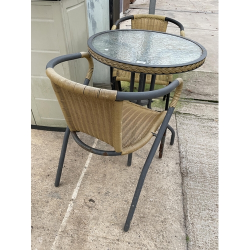 1629 - A GLASS TOPPED BISTRO TABLE AND TWO RATTAN EFFECT CHAIRS