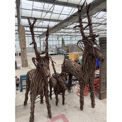 1661 - THREE GRADUATED WICKER REINDEER