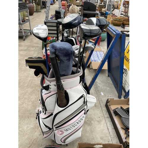 1716 - A MOTORCADDY GOLF BAG AND CLUBS TO INCLUDE A KING COBRA DRIVER AND A HIPPO DRIVER AND WOODS