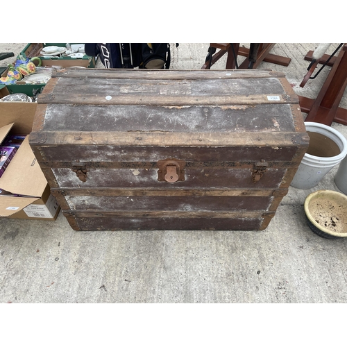 1765 - A VINTAGE DOMED TRAVEL TRUNK WITH METAL BANDING