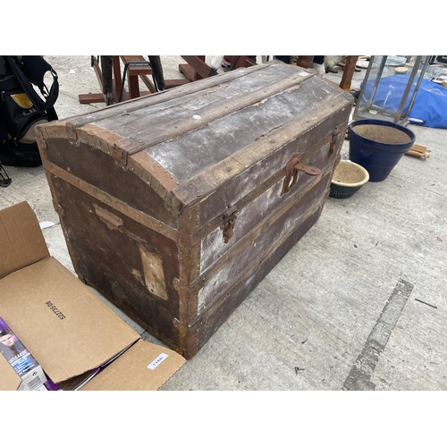 1765 - A VINTAGE DOMED TRAVEL TRUNK WITH METAL BANDING