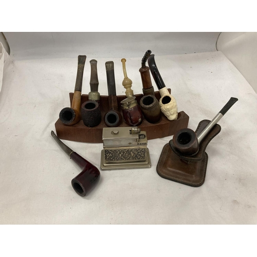 26 - EIGHT VINTAGE PIPES WITH STANDS AND A TABLE LIGHTER