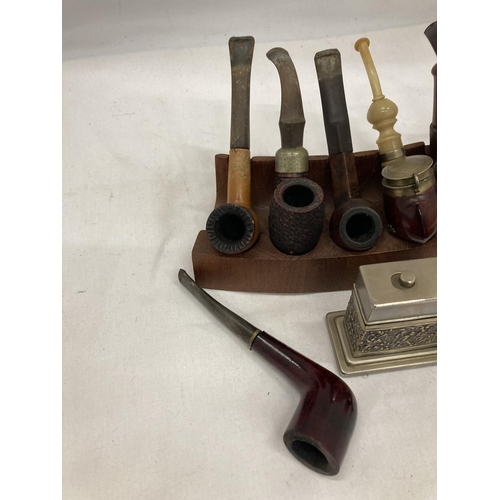 26 - EIGHT VINTAGE PIPES WITH STANDS AND A TABLE LIGHTER