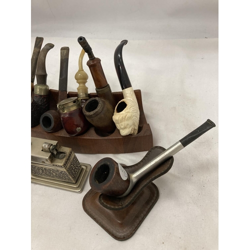 26 - EIGHT VINTAGE PIPES WITH STANDS AND A TABLE LIGHTER