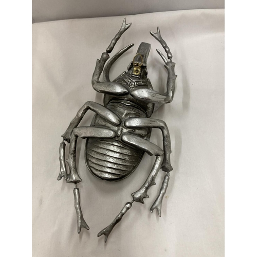 293 - A LARGE SILVER COLOURED WALL HANGING BEETLE