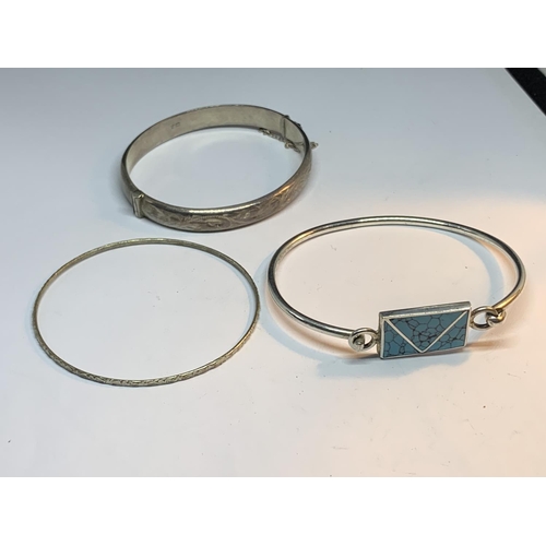 695 - THREE SILVER BANGLES