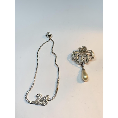 696 - TWO SWAROVSKI CRYSTAL ITEMS TO INCLUDE A SWAN BRACELET AND A BROOCH