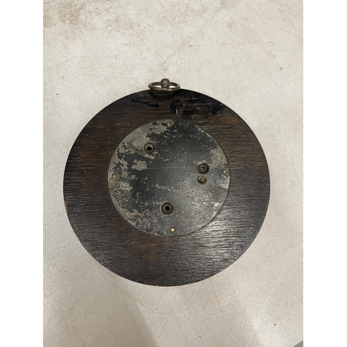 60 - A CIRCULAR BAROMETER WITH A CARVED FRAME