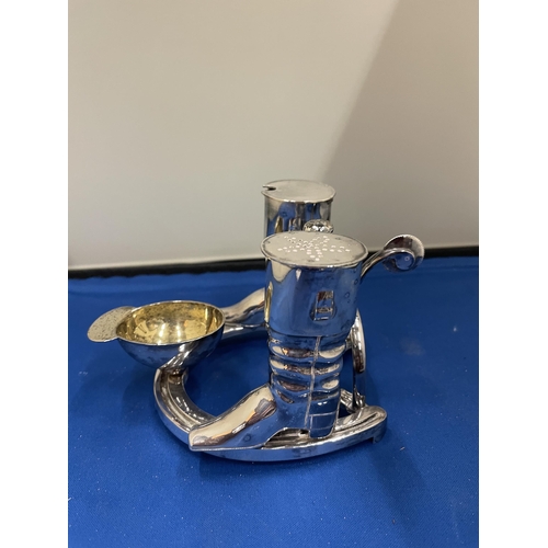 65 - AN ELKINGTON SILVER PLATED CRUET SET IN THE GUISE OF RIDING BOOTS AND HAT ST ON A HORSE SHOE BASE