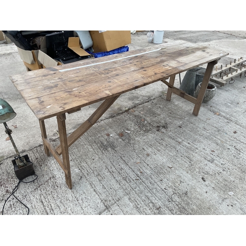 1967 - A WOODEN FOLDING TRESTLE TABLE