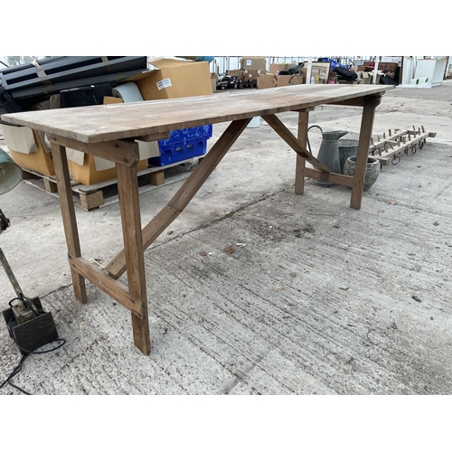 1967 - A WOODEN FOLDING TRESTLE TABLE