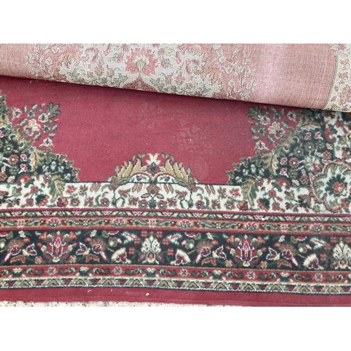 2492 - A LARGE RED PATTERNED RUG