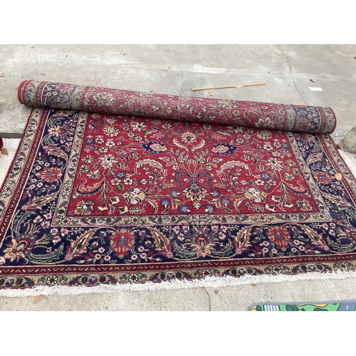 2493 - A LARGE RED PATTERNED FRINGED RUG