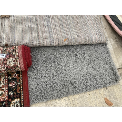 2494 - A SMALL RED PATTERNED RUG AND A MODERN GREY RUG