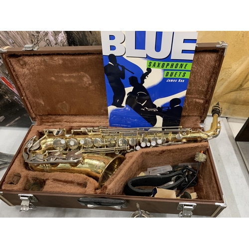 9 - A YAMAHA SAXOPHONE WITH CASE AND A TEACHING BOOK