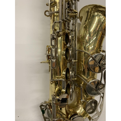 9 - A YAMAHA SAXOPHONE WITH CASE AND A TEACHING BOOK