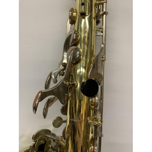 9 - A YAMAHA SAXOPHONE WITH CASE AND A TEACHING BOOK