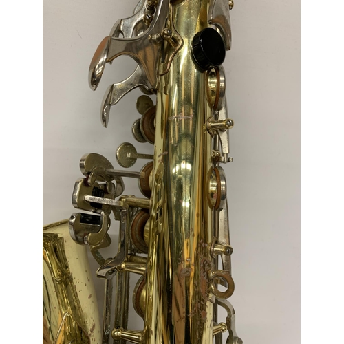 9 - A YAMAHA SAXOPHONE WITH CASE AND A TEACHING BOOK