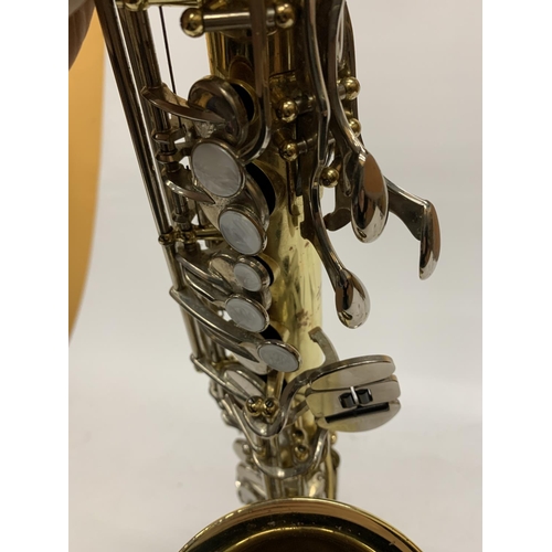 9 - A YAMAHA SAXOPHONE WITH CASE AND A TEACHING BOOK