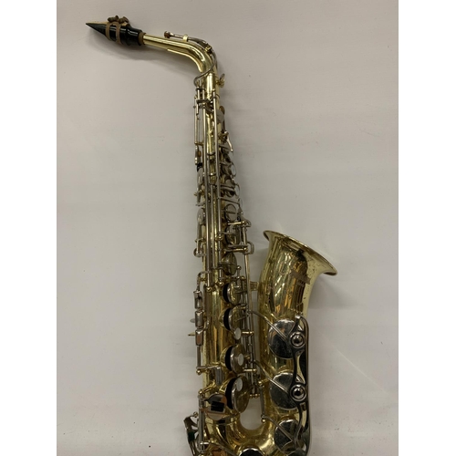 9 - A YAMAHA SAXOPHONE WITH CASE AND A TEACHING BOOK