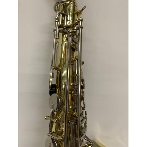 9 - A YAMAHA SAXOPHONE WITH CASE AND A TEACHING BOOK