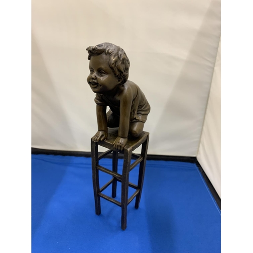 2 - A BRONZE MODEL OF A CHILD KNEELING ON A STOOL SIGNED