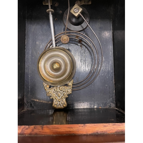 59 - AN OAK CASE CHIMING WALL CLOCK