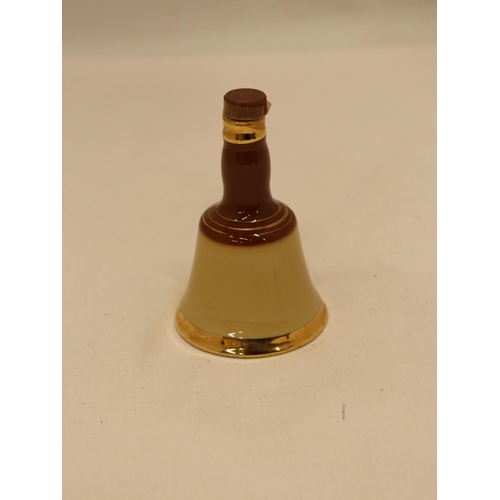 117 - A SMALL FULL BELL'S CERAMIC WHISKY DECANTER, HEIGHT 10CM