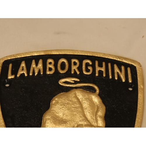 123 - A TRIANGULAR BLACK AND GOLD CAST METAL LAMBORGHINI SIGN, 21CM X 18CM