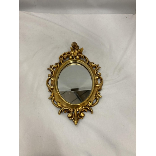 205 - A SMALL OVAL GILT MIRROR, PLEASE NOTE THE SIZE, 19CM X 29CM