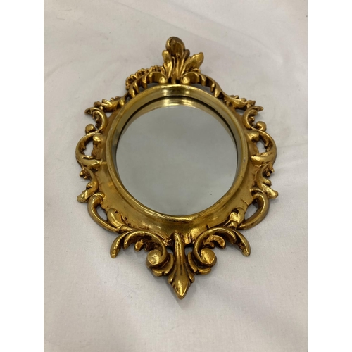 205 - A SMALL OVAL GILT MIRROR, PLEASE NOTE THE SIZE, 19CM X 29CM