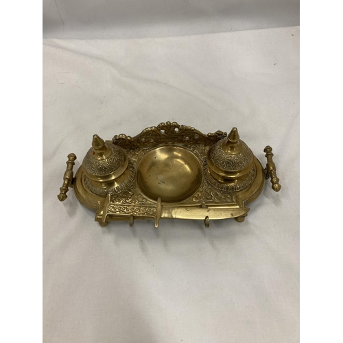 208 - AN ORNATE VINTAGE BRASS INKWELL STAND