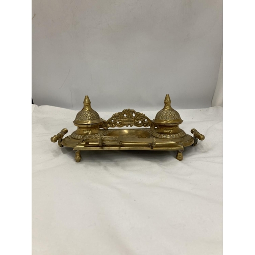 208 - AN ORNATE VINTAGE BRASS INKWELL STAND