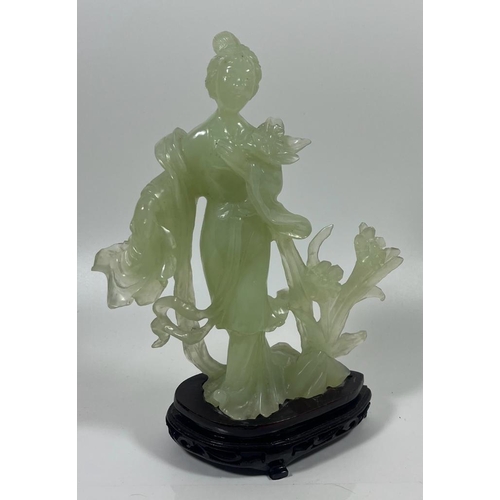 302 - A VINTAGE JADEITE JADE TYPE FIGURE ON A WOODEN DISPLAY BASE, HEIGHT 23 CM