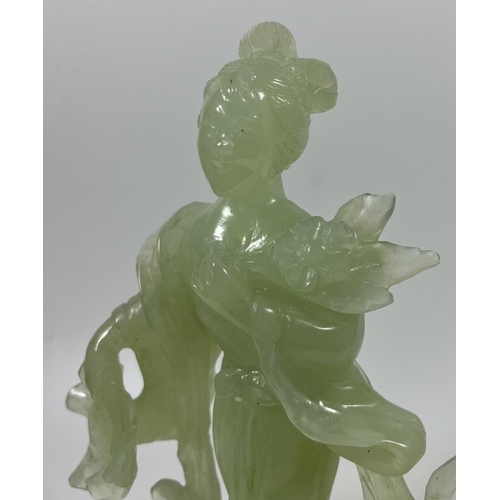 302 - A VINTAGE JADEITE JADE TYPE FIGURE ON A WOODEN DISPLAY BASE, HEIGHT 23 CM