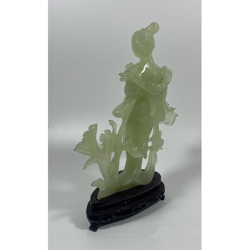 302 - A VINTAGE JADEITE JADE TYPE FIGURE ON A WOODEN DISPLAY BASE, HEIGHT 23 CM