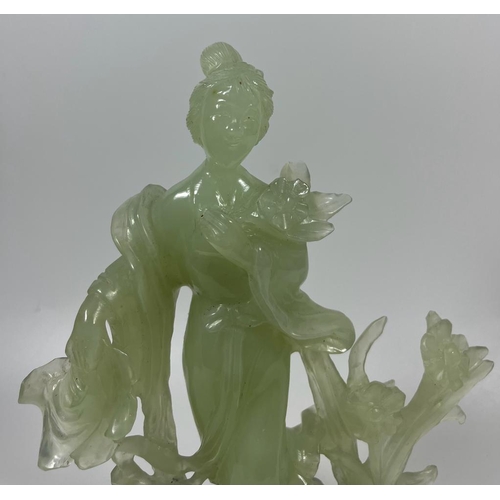 302 - A VINTAGE JADEITE JADE TYPE FIGURE ON A WOODEN DISPLAY BASE, HEIGHT 23 CM