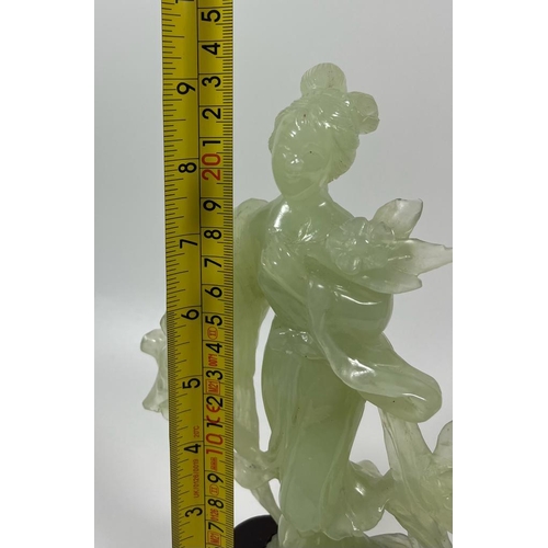 302 - A VINTAGE JADEITE JADE TYPE FIGURE ON A WOODEN DISPLAY BASE, HEIGHT 23 CM